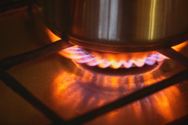 Gas stove burner with blue and orange flame for gas line service representation